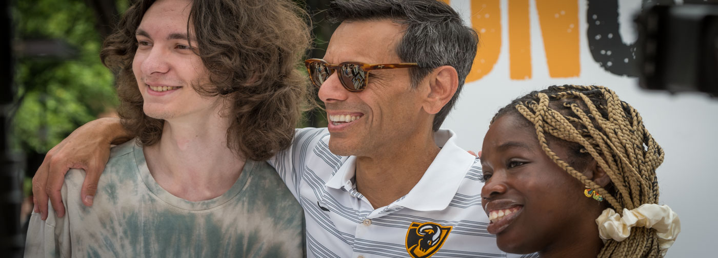 Michael Rao, Ph.D. posing for a photograph with two VCU students