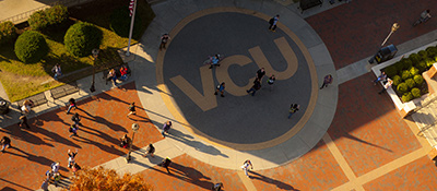 Area outside of the Commons building with VCU spelled in the brickwork
